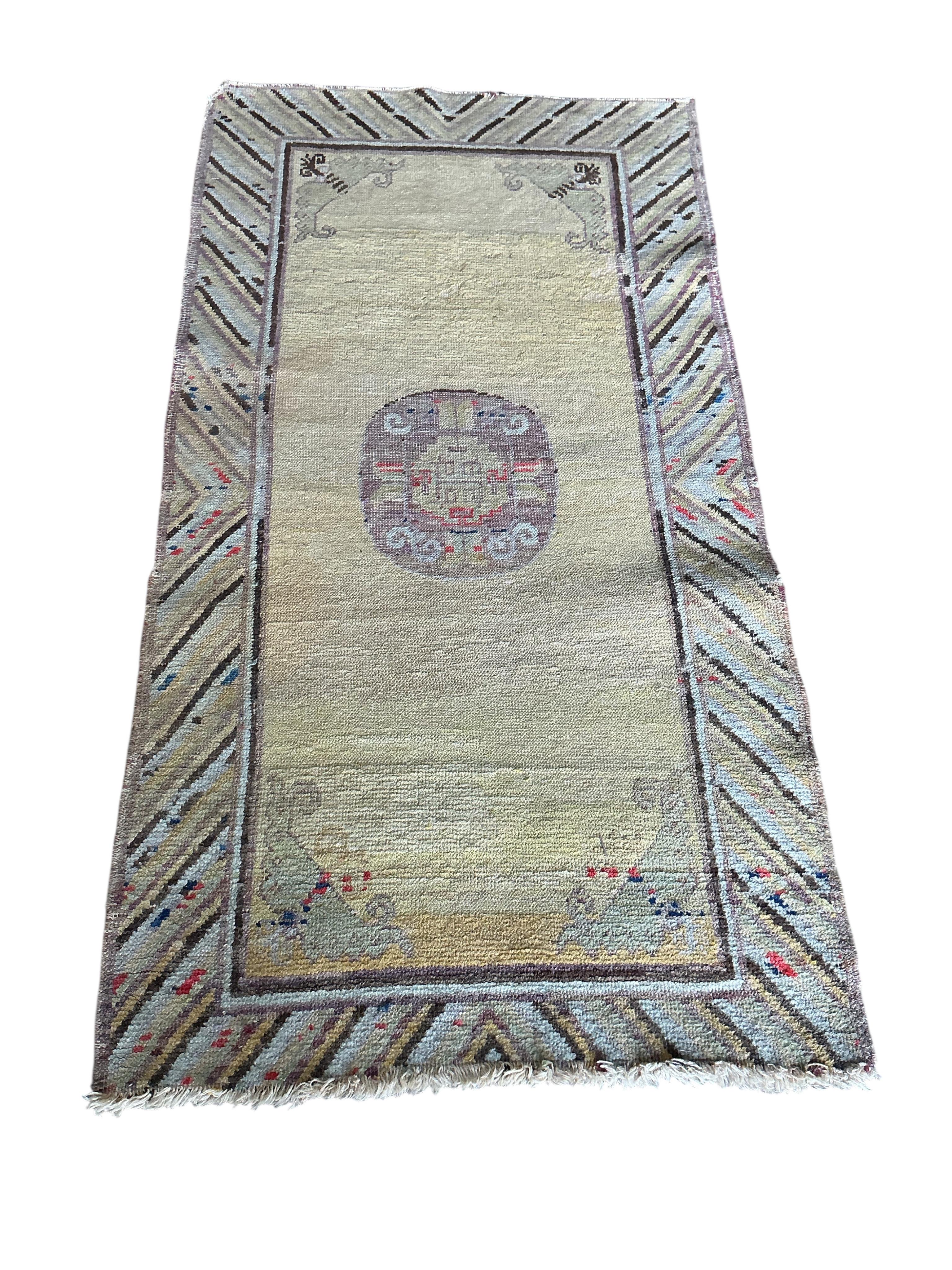 A Tibetan yellow ground rug, 134 x 70cm